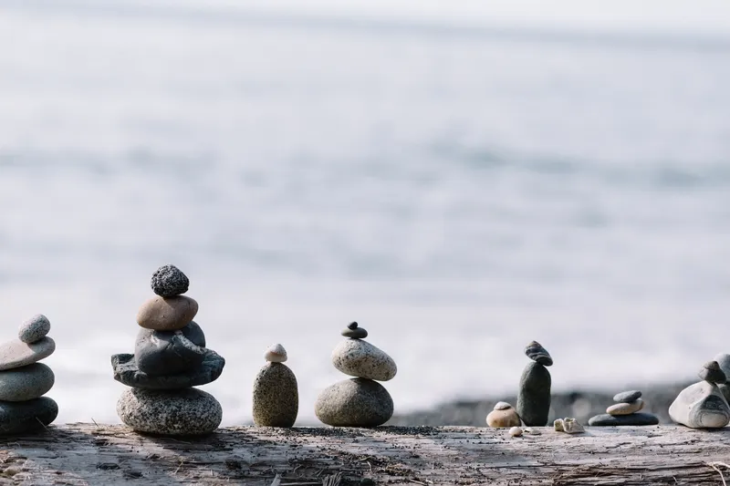 Stacked stones on a quiet shoreline